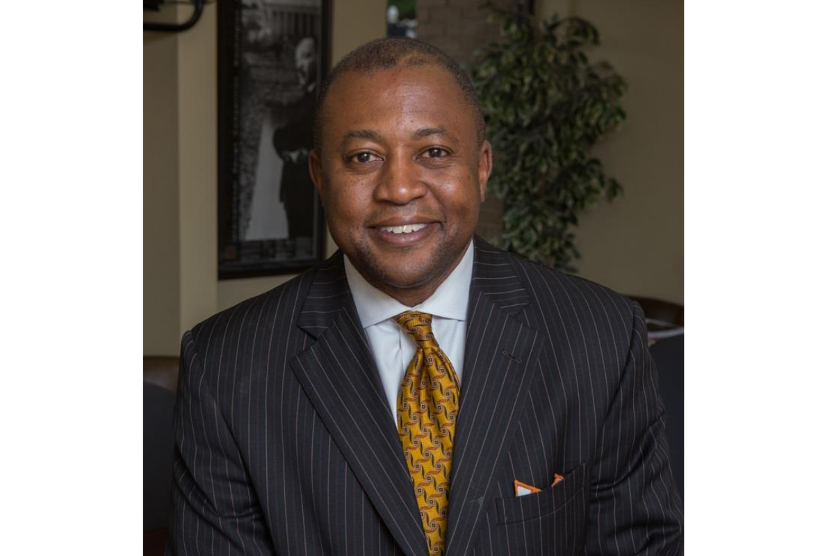 Darrin Thomas in dark suit and rust-colored tie.