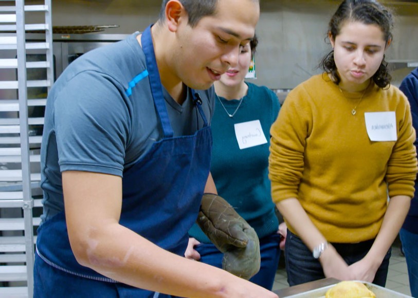 Adrian Espinoza Garcia showing others how to make empanadas.