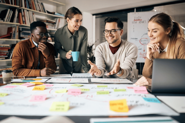 Diverse Marketing team around whiteboard with sticky notes