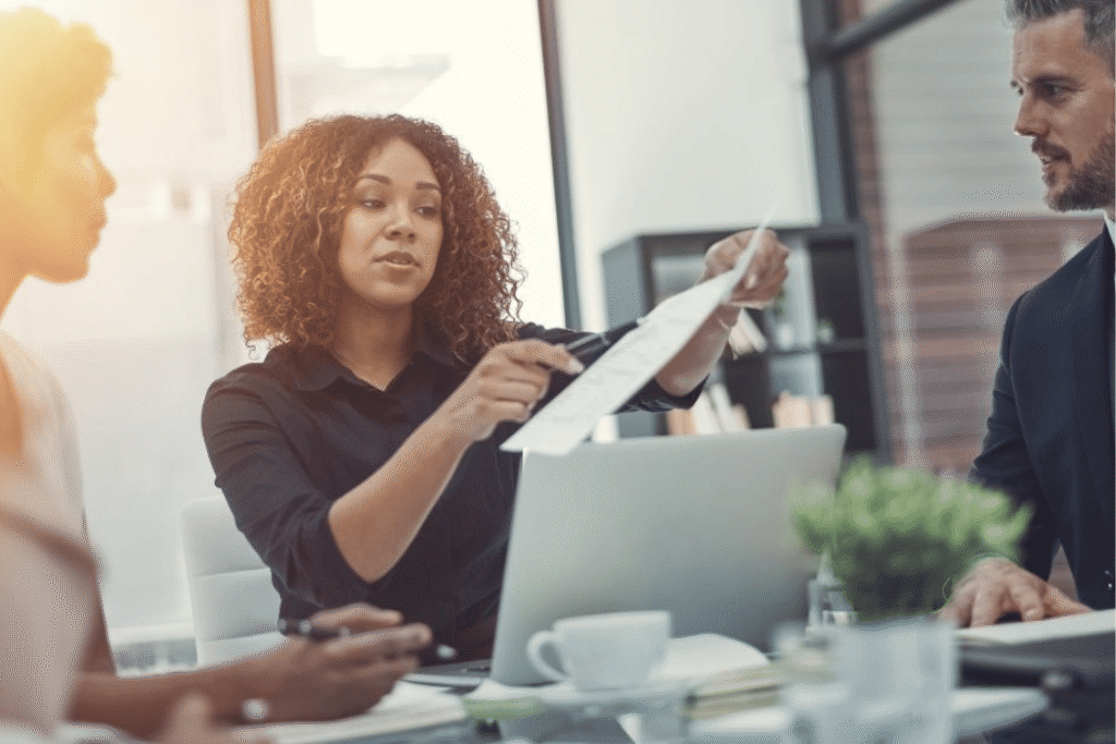 Woman at desk holding paper banner
