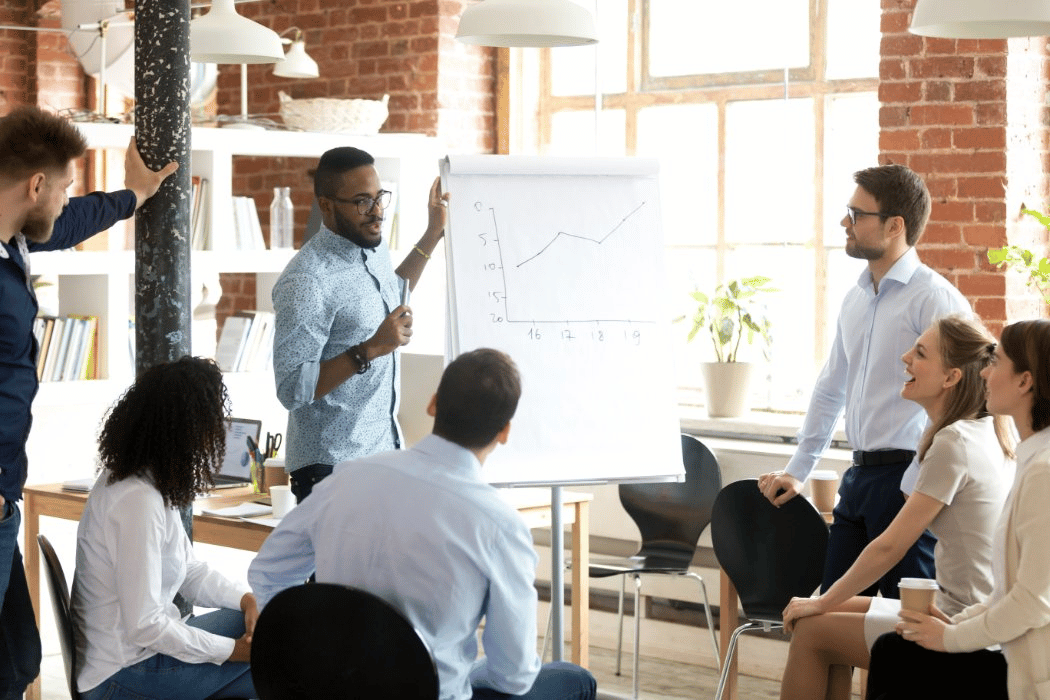 Young, diverse professionals in office setting review office space plans