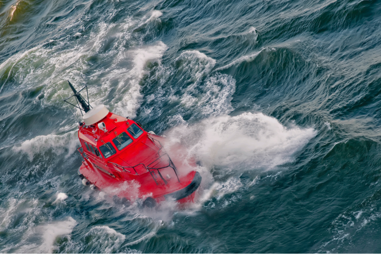 Red boat sailing on a stormy sea