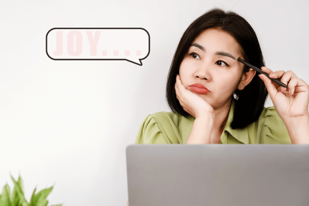Sad woman sitting in front of laptop separated from joy