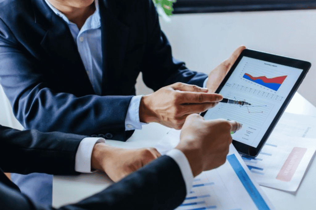 Two men looking at financial charts
