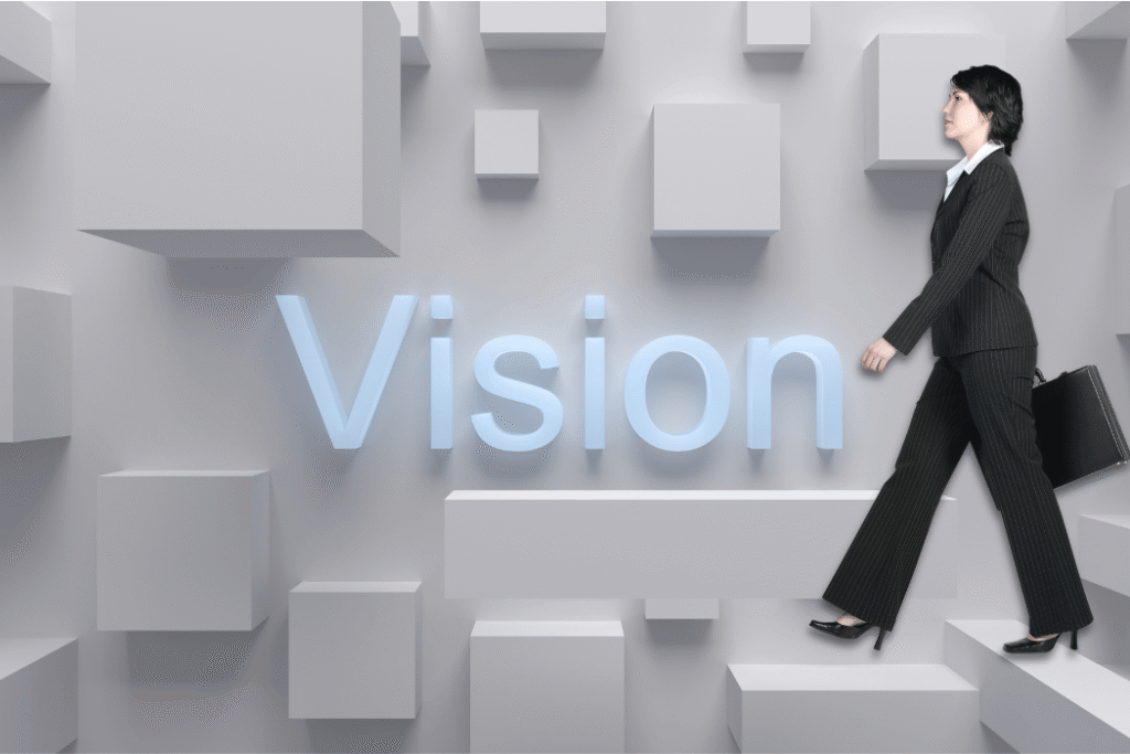 Woman walking on a backdrop that says Vision