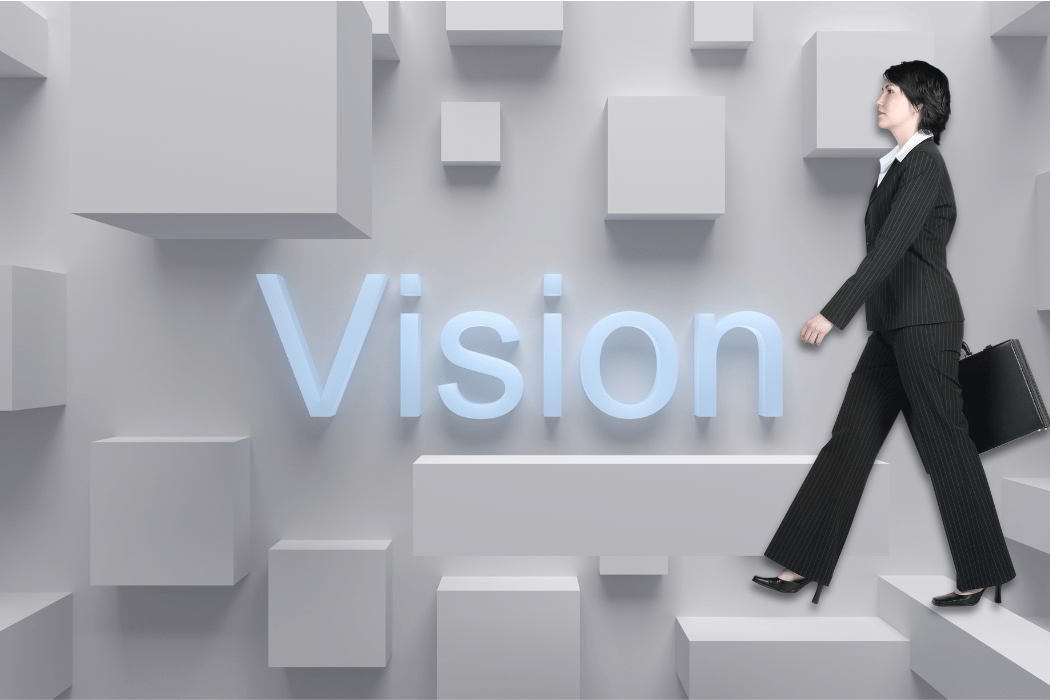 Woman walking on a backdrop that says Vision