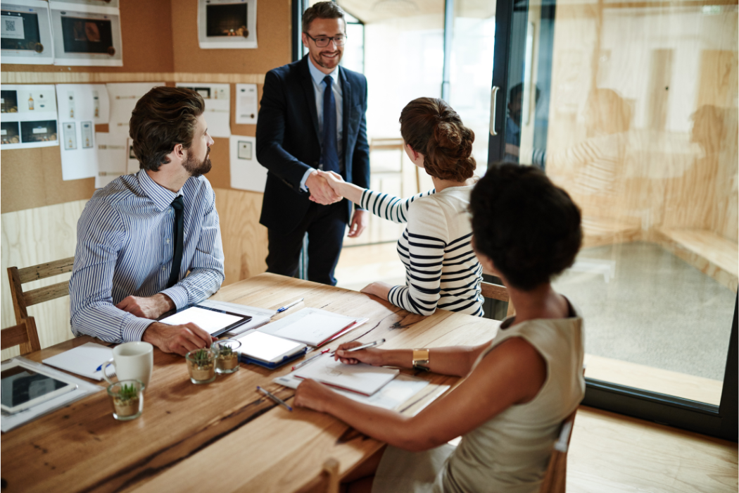 Group of business people greeting a client