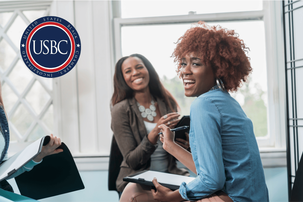 Black woman business owner laughing with customer