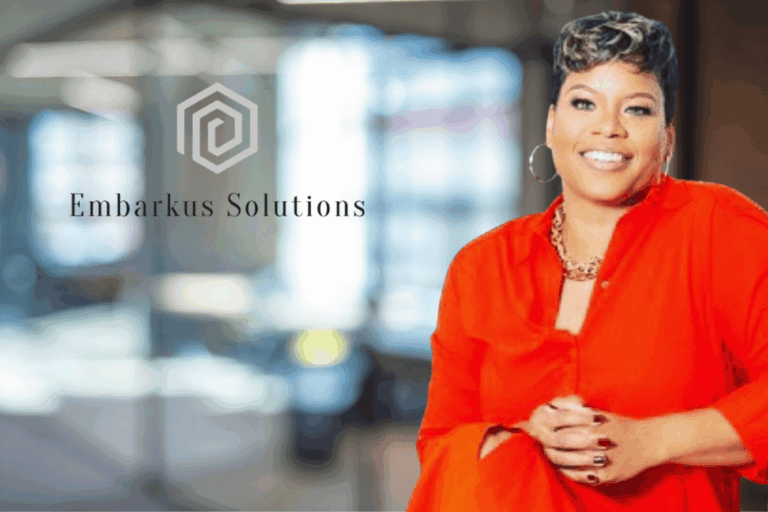 Ebony Karim in a red suit with a big smile