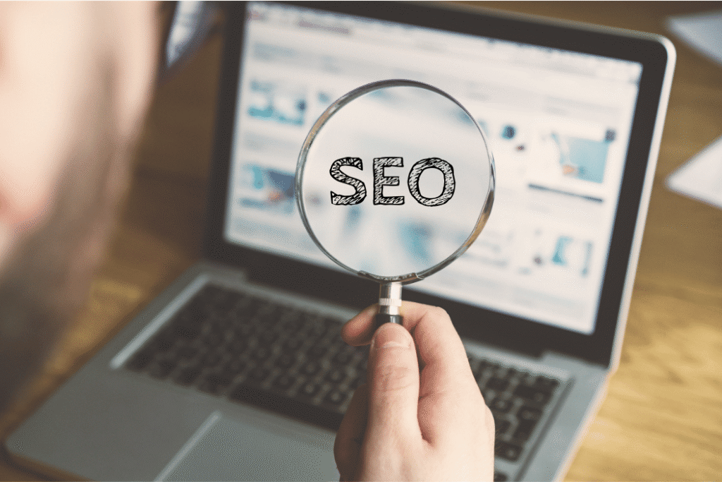 Magnifying glass highlighting SEO on laptop screen