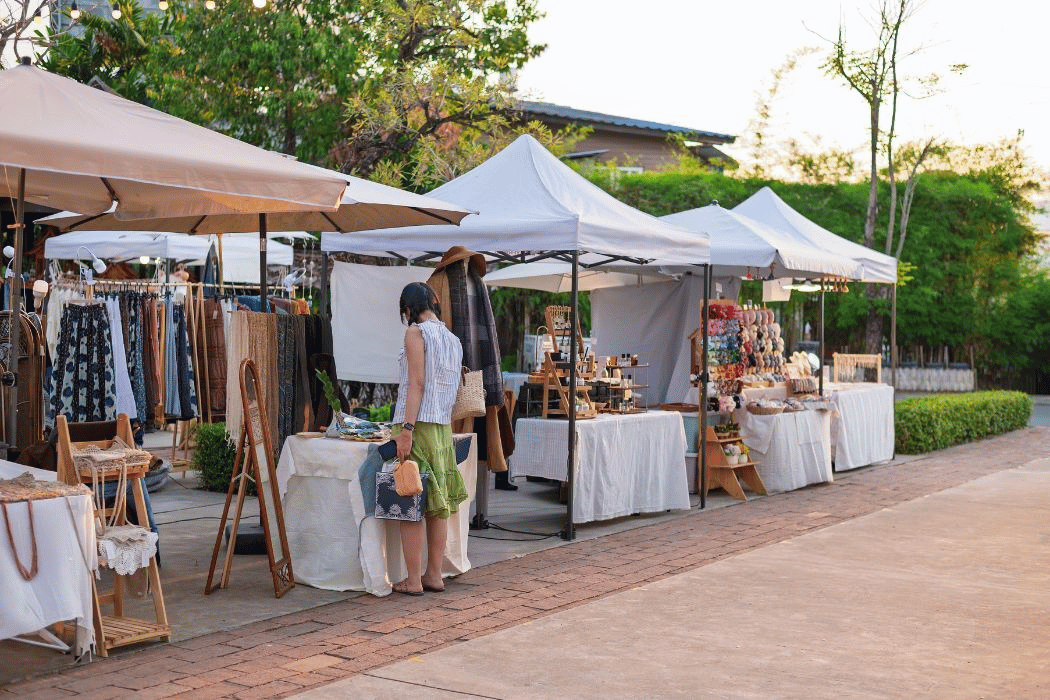 Woman perusing items at vendor market