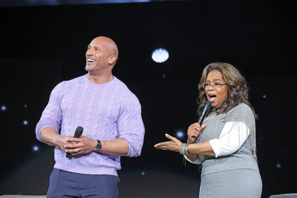 Dwayne "The Rock" Johnson and Oprah Winfrey appear on stage at Oprah's Vision Tour.