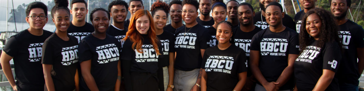 A group of Black and Latinx students in black HBCU t-shirts standing together.
