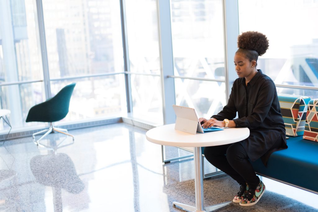 A woman sits at a laptop - Applications Open for Coalition to Back Black Businesses 2022-23 Grants