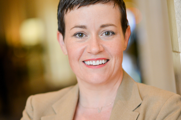 Headshot of white woman with short hair smiling.